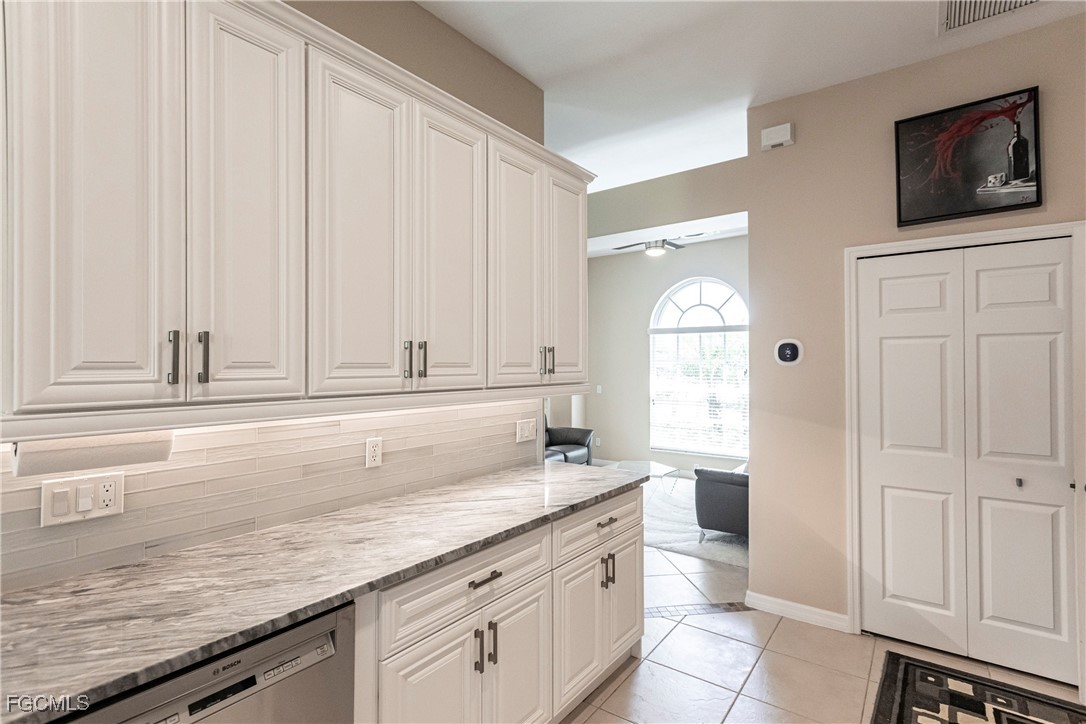 9013 West Ridge Court Fort Myers, FL 33912 - Photo 13 of 43 a kitchen with granite countertop a sink and a stove