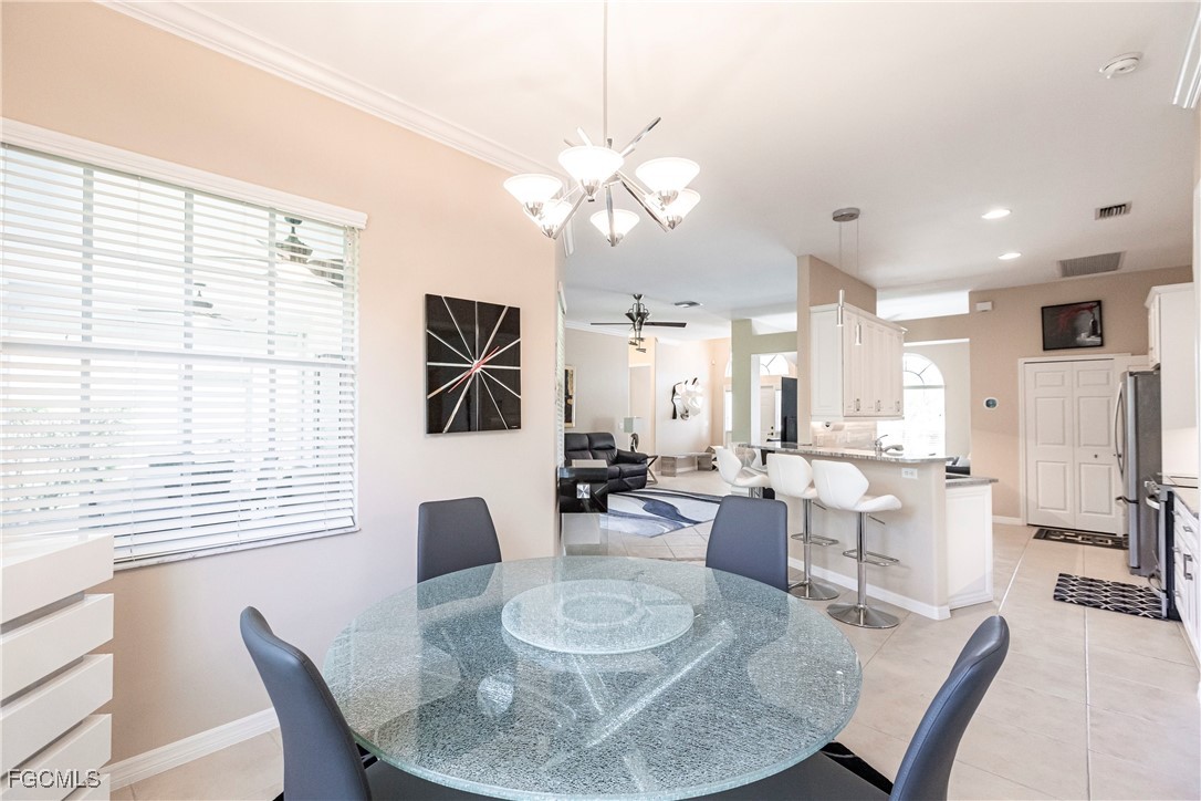 9013 West Ridge Court Fort Myers, FL 33912 - Photo 20 of 43 a dining room with furniture and a large window