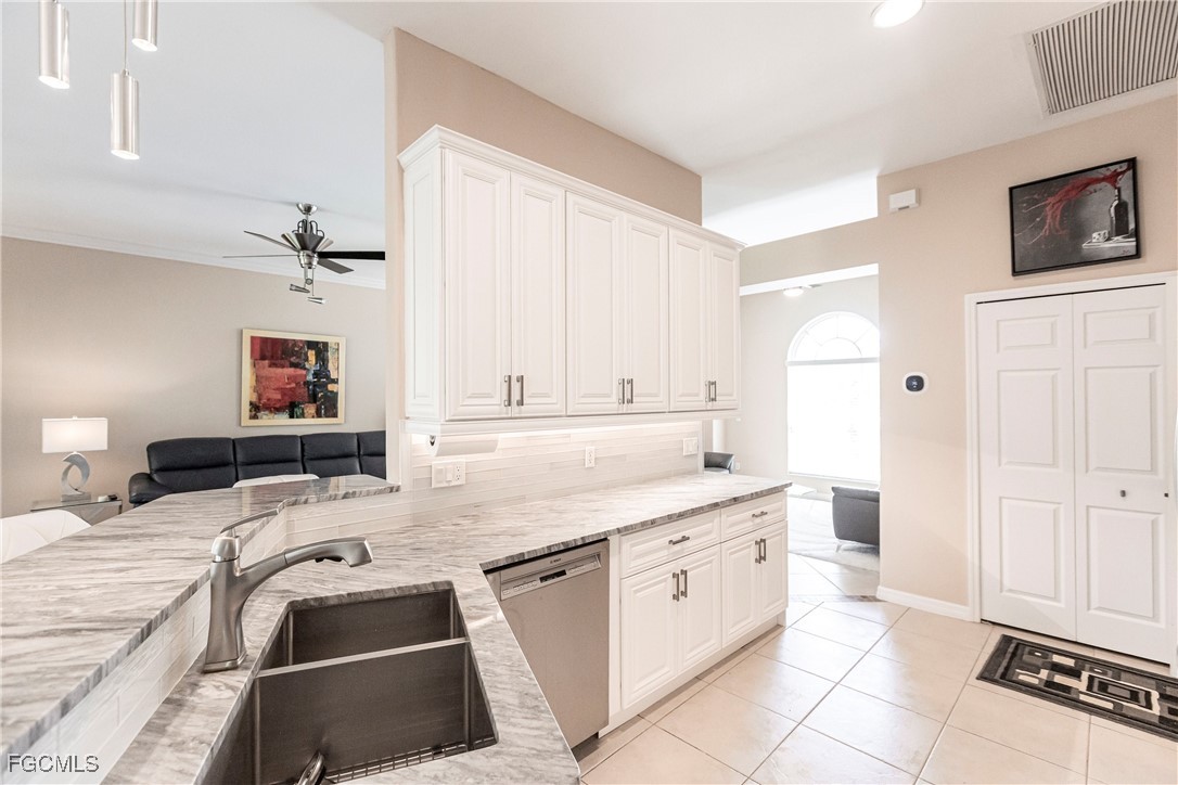 9013 West Ridge Court Fort Myers, FL 33912 - Photo 2 of 43 a kitchen that has a sink and a stove in it