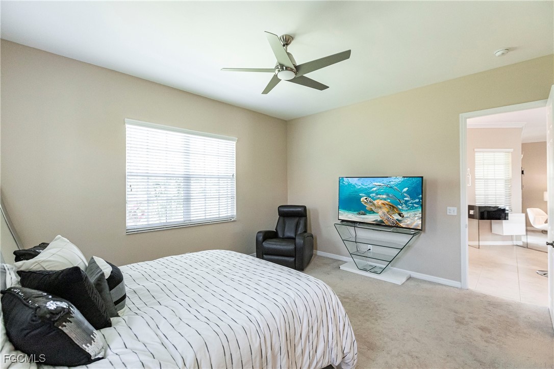 9013 West Ridge Court Fort Myers, FL 33912 - Photo 23 of 43 a bedroom with a bed and a flat screen tv