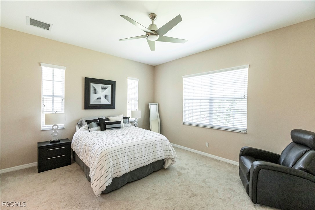 9013 West Ridge Court Fort Myers, FL 33912 - Photo 25 of 43 a bedroom with a bed couches and window