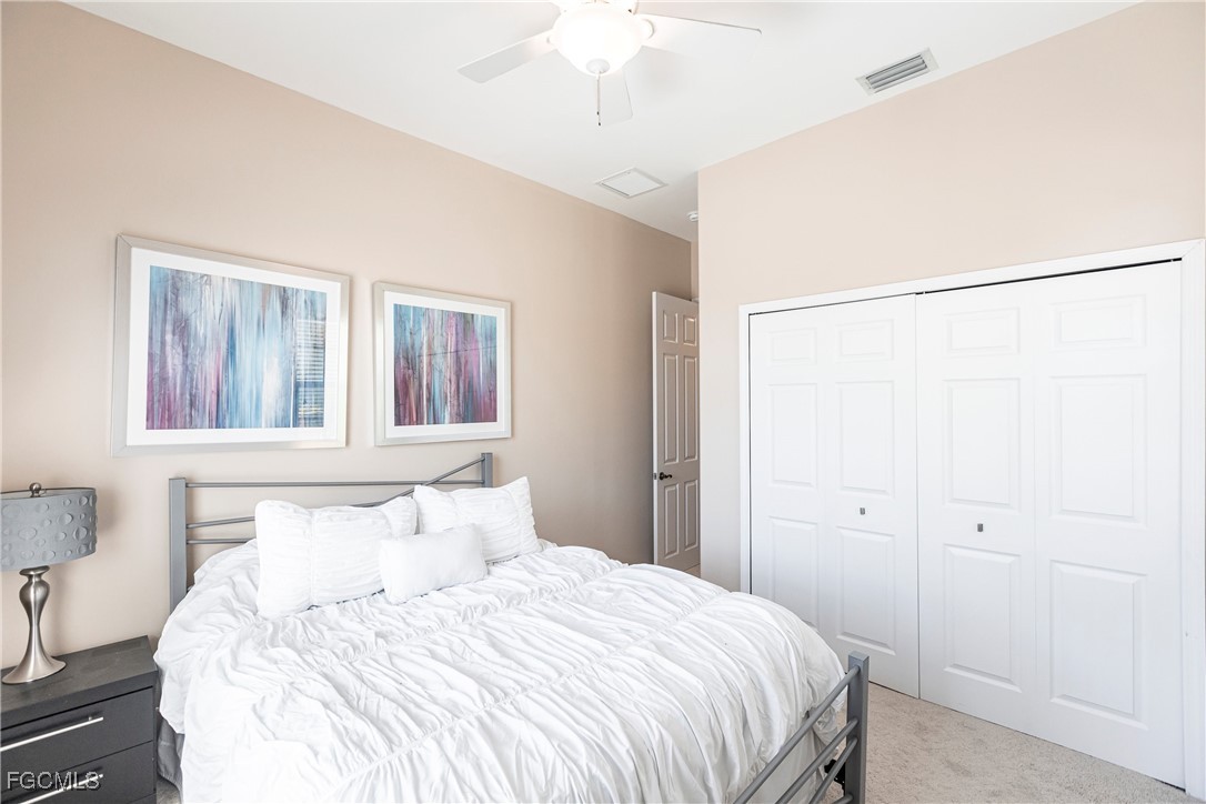 9013 West Ridge Court Fort Myers, FL 33912 - Photo 29 of 43 a bedroom with a bed and a chandelier