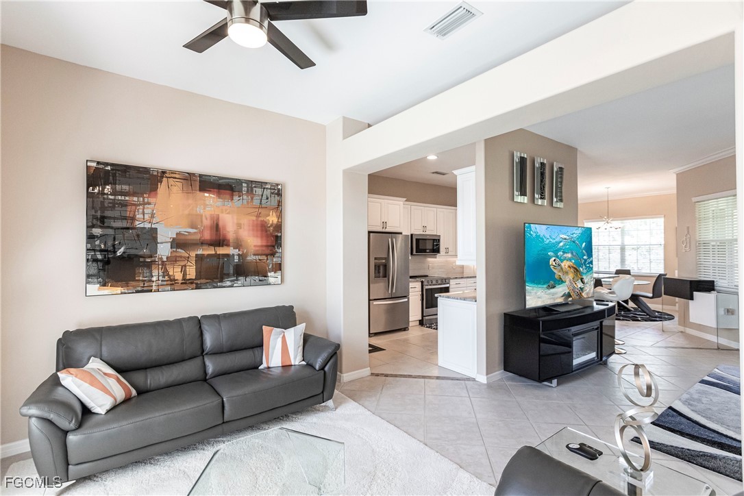 9013 West Ridge Court Fort Myers, FL 33912 - Photo 3 of 43 a living room with furniture and a flat screen tv