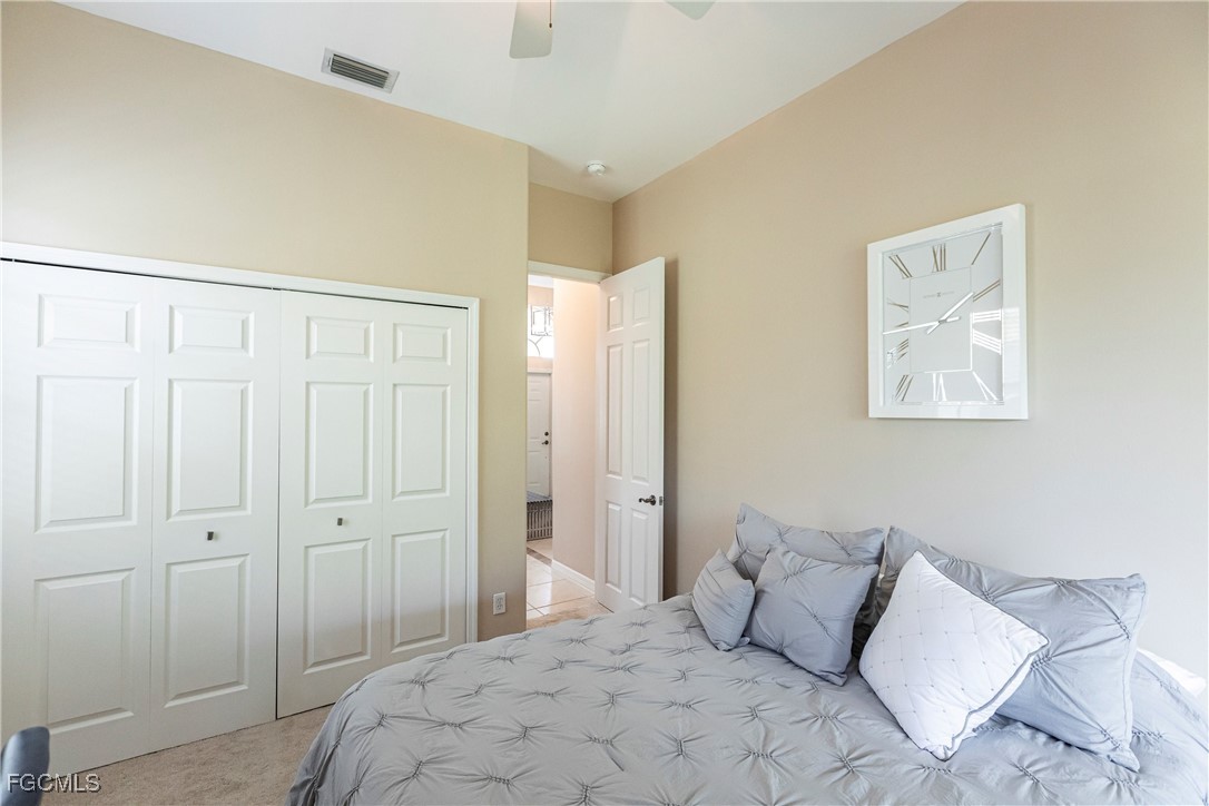 9013 West Ridge Court Fort Myers, FL 33912 - Photo 32 of 43 a bedroom with a bed and a closet
