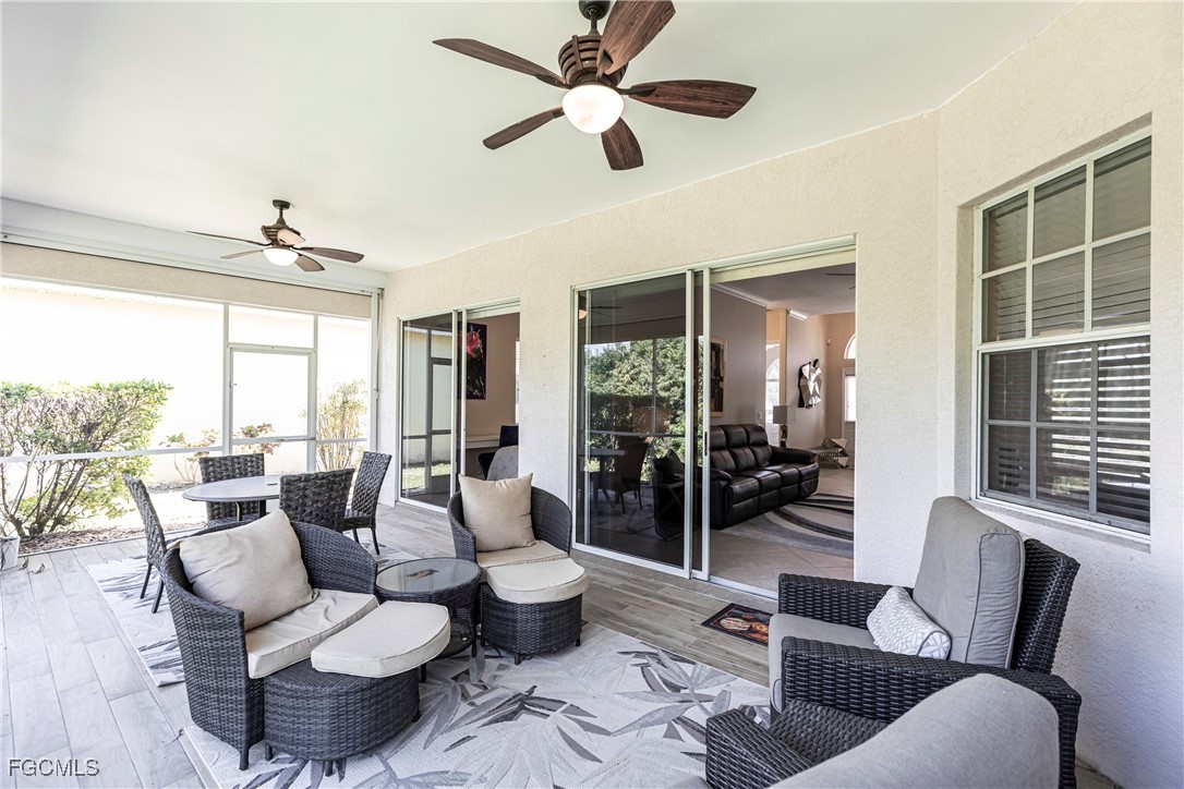 9013 West Ridge Court Fort Myers, FL 33912 - Photo 36 of 43 a living room with furniture and a large window with wooden floor