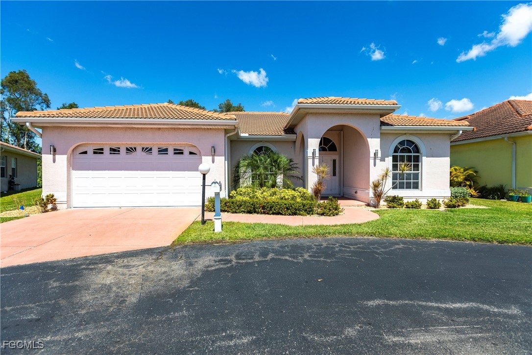 9013 West Ridge Court Fort Myers, FL 33912 - Photo 4 of 43 a front view of a house with a yard and garage