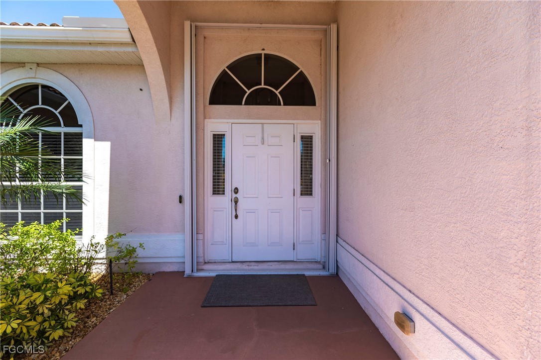 9013 West Ridge Court Fort Myers, FL 33912 - Photo 5 of 43 a front view of a house with a yard