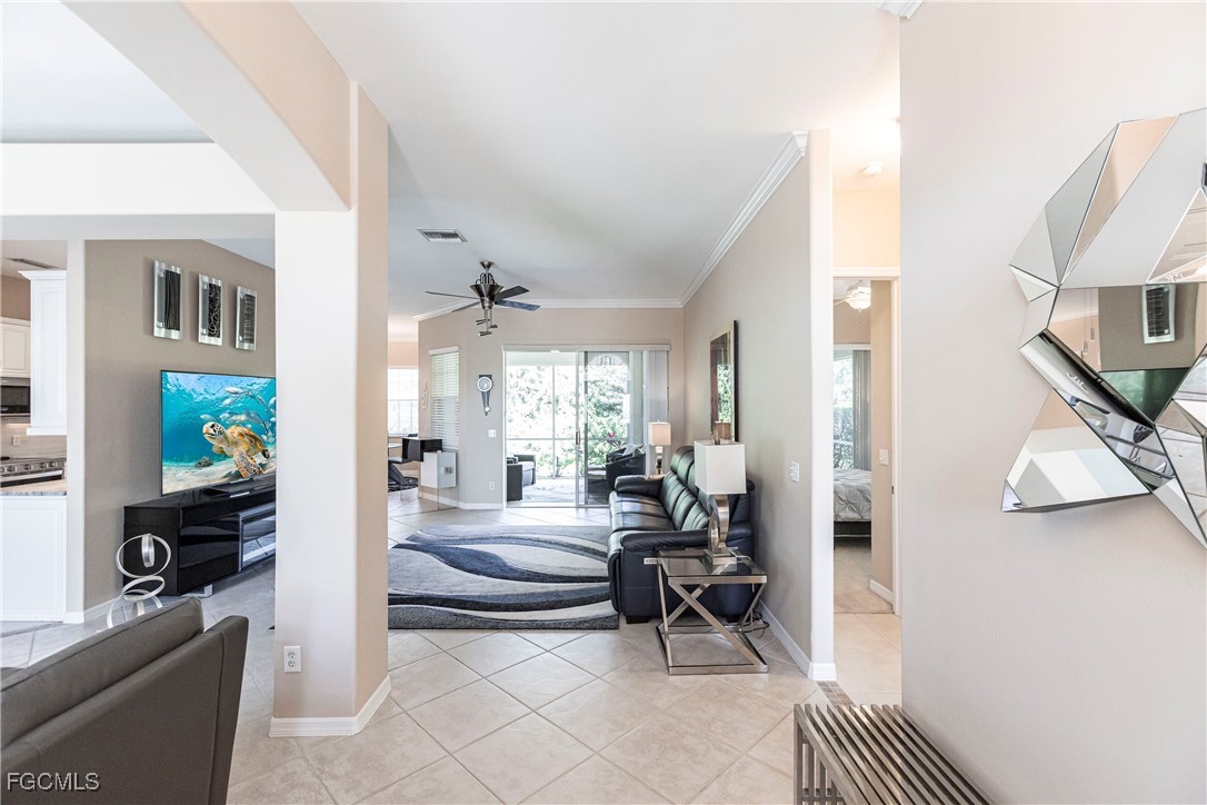 9013 West Ridge Court Fort Myers, FL 33912 - Photo 6 of 43 a living room with furniture a fireplace and a table