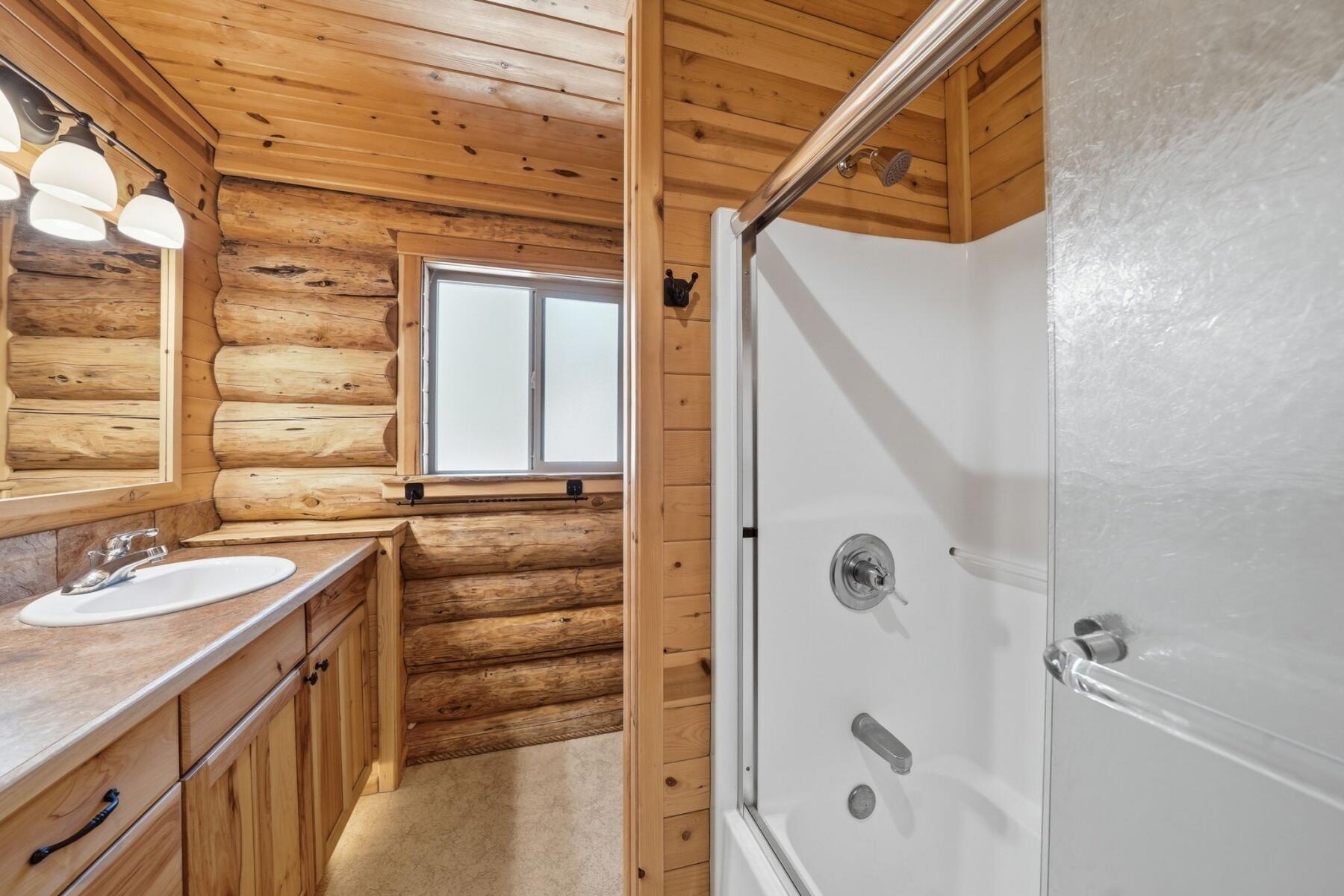 14177 Whitewater Loop La Pine, OR 97739 - Photo 12 of 38 a bathroom with a granite countertop sink a mirror and shower