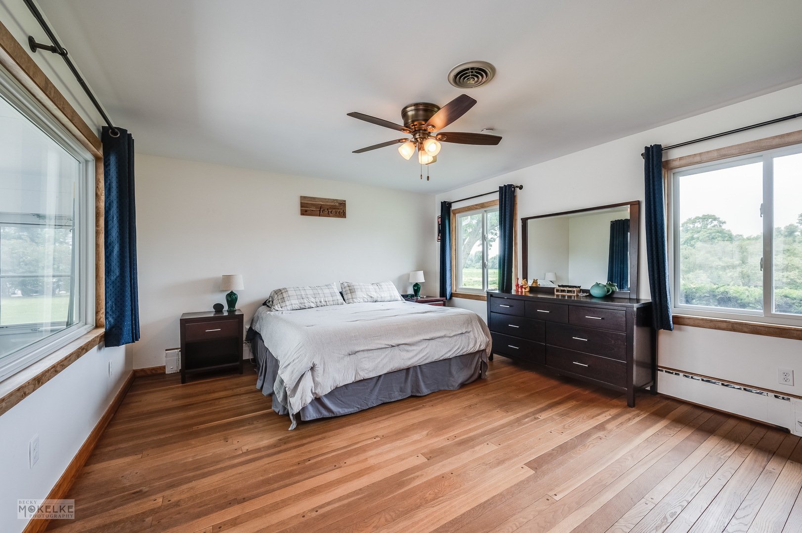 2512 Caton Farm Road Joliet, IL 60435 - Photo 25 of 41 a spacious bedroom with a bed and a large window with wooden floor