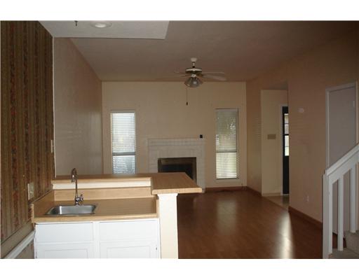 2801 St Joseph Street, Unit H Corpus Christi, TX 78418 - Photo 2 of 4 a living room with a fireplace furniture and a window