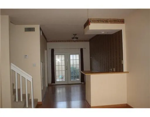 a view of an entryway with wooden floor