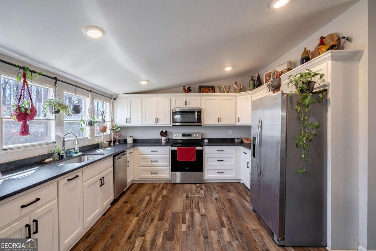 218 Sol Drive Commerce, GA 30529 - Photo 13 of 48 a kitchen with stainless steel appliances granite countertop a refrigerator and a stove top oven