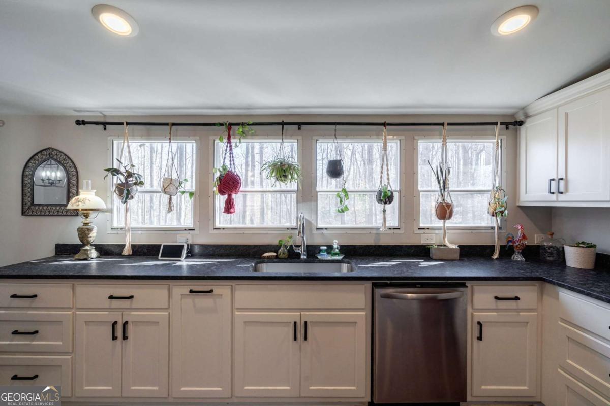 218 Sol Drive Commerce, GA 30529 - Photo 14 of 48 a kitchen with granite countertop a stove a sink and a granite counter tops