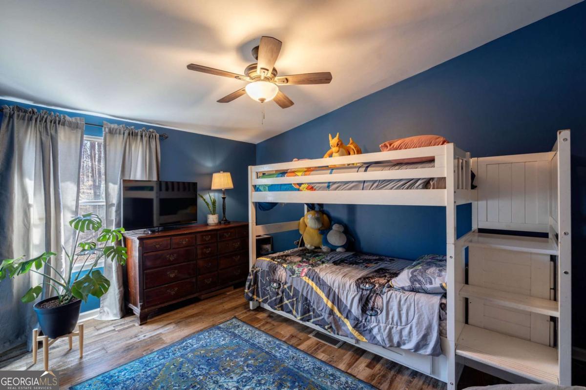 218 Sol Drive Commerce, GA 30529 - Photo 25 of 48 a bedroom with a bed and a chandelier