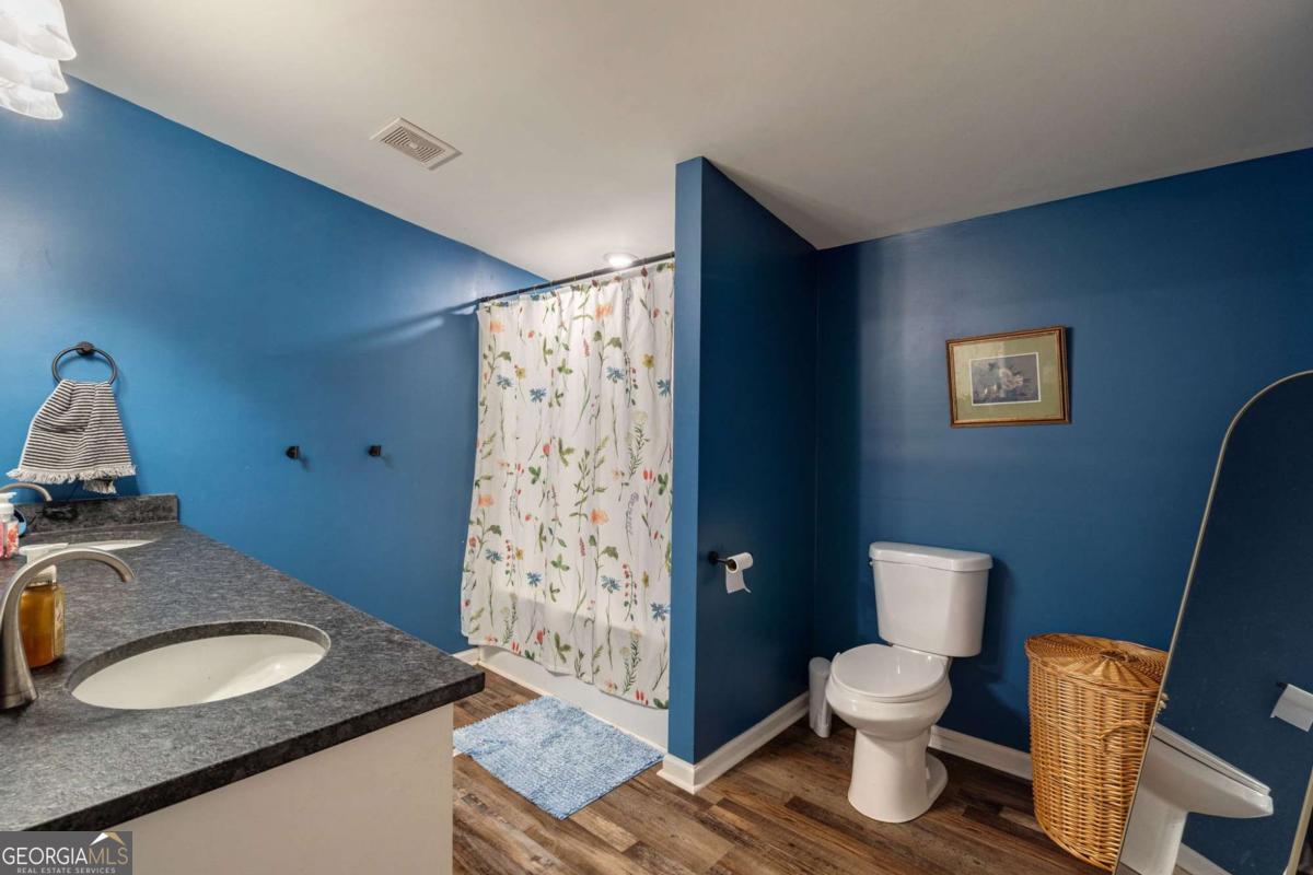 218 Sol Drive Commerce, GA 30529 - Photo 27 of 48 a bathroom with a granite countertop toilet sink and mirror