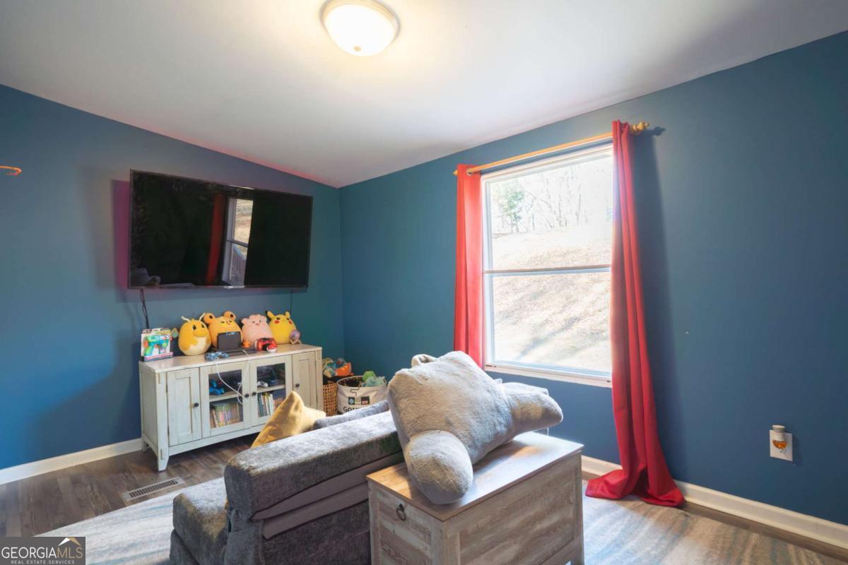 218 Sol Drive Commerce, GA 30529 - Photo 31 of 48 a living room with furniture and a flat screen tv