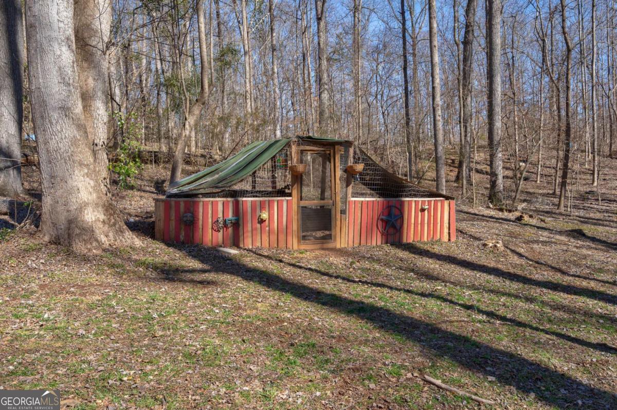 218 Sol Drive Commerce, GA 30529 - Photo 36 of 48 a view of a house with a small yard and large trees