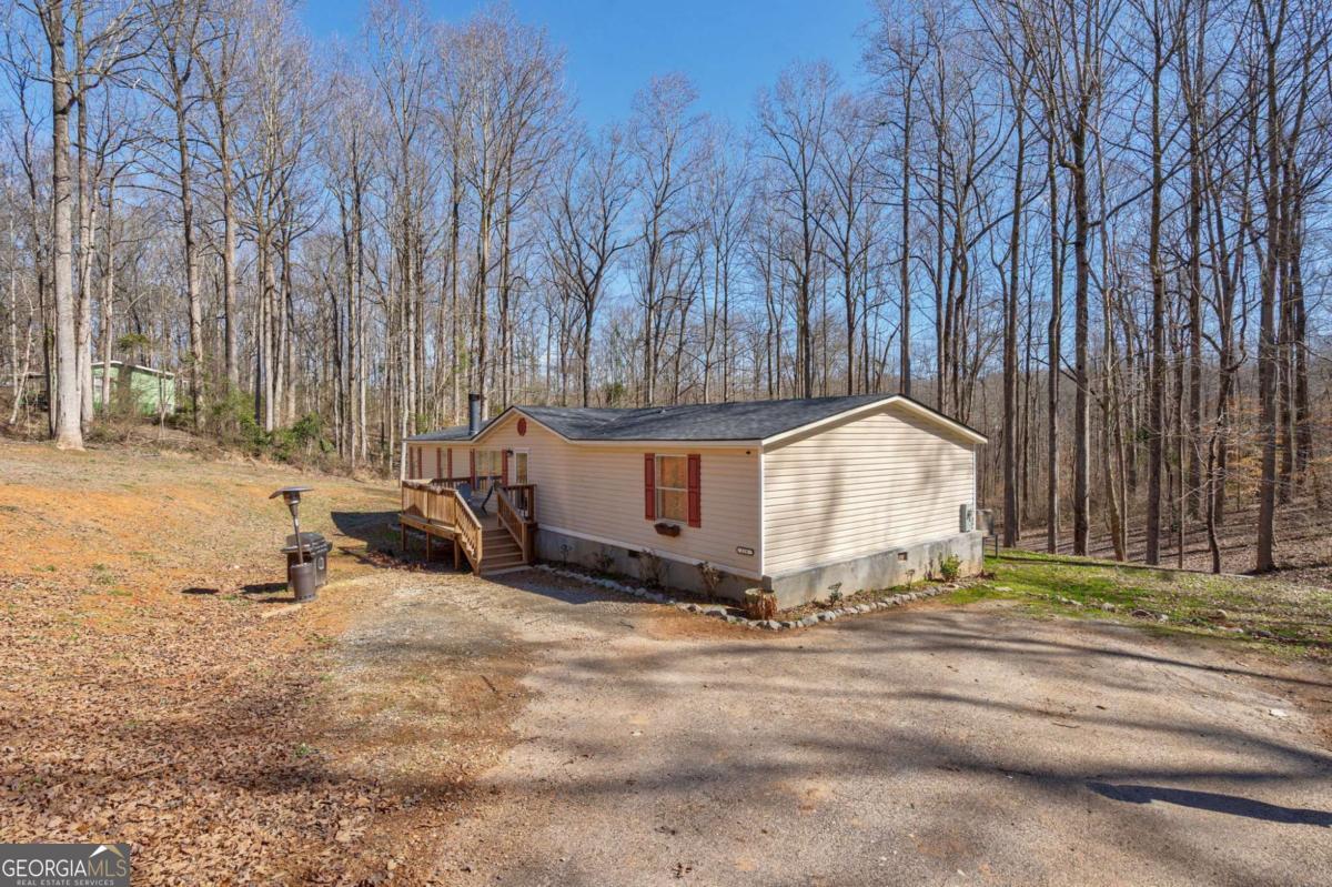 218 Sol Drive Commerce, GA 30529 - Photo 41 of 48 a white house that has a tree in front of it