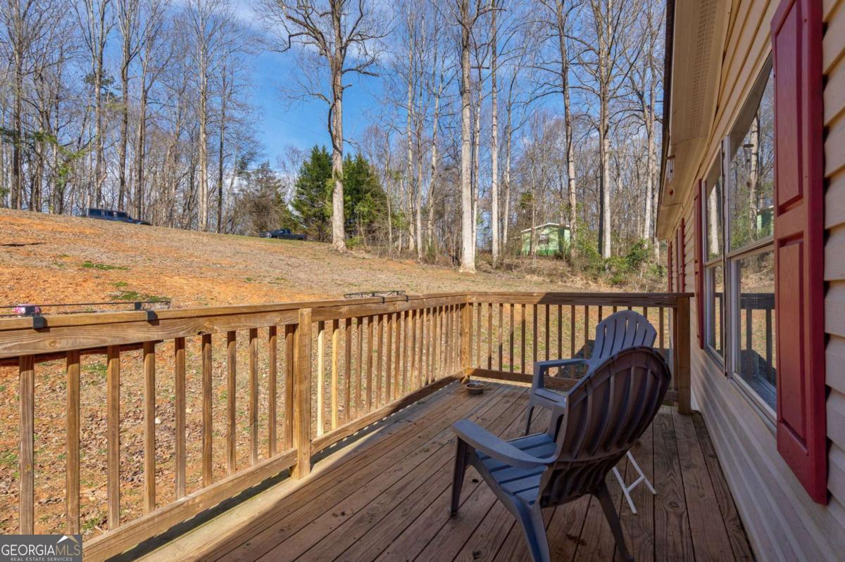 218 Sol Drive Commerce, GA 30529 - Photo 45 of 48 a view of a balcony with wooden chairs and floor