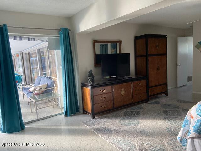146 Bimini Road Cocoa Beach, FL 32931 - Photo 12 of 41 a living room with furniture and a flat screen tv