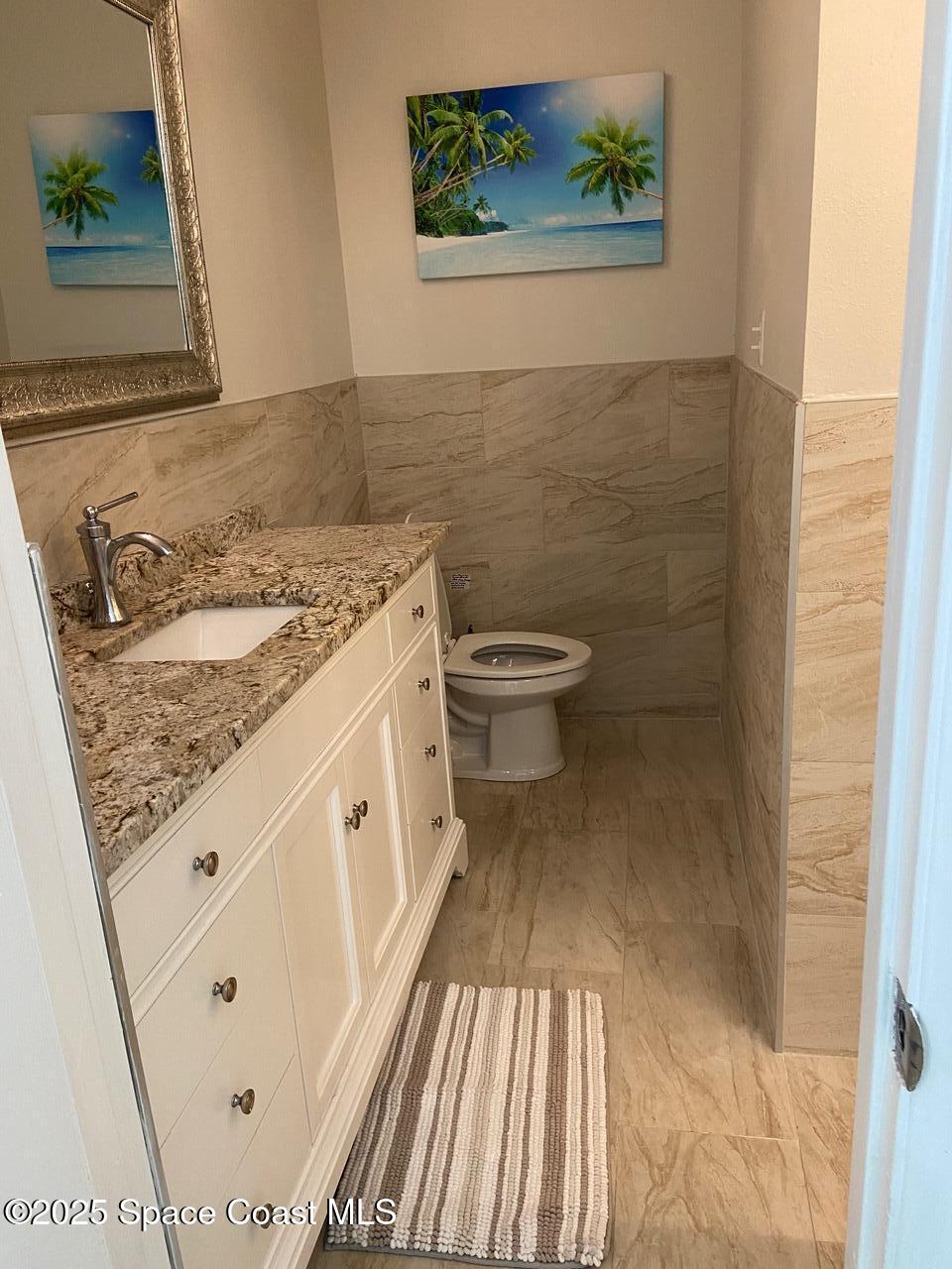 146 Bimini Road Cocoa Beach, FL 32931 - Photo 14 of 41 a view of a bathroom with a sink and toilet