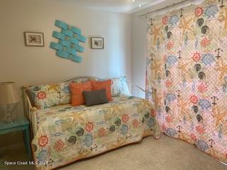 146 Bimini Road Cocoa Beach, FL 32931 - Photo 17 of 41 a bedroom with a bed and painting on the wall