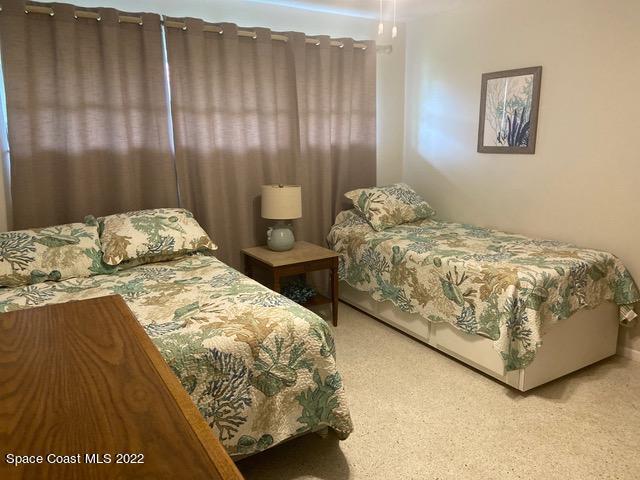 146 Bimini Road Cocoa Beach, FL 32931 - Photo 21 of 41 a bedroom with a bed and curtain