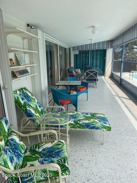 146 Bimini Road Cocoa Beach, FL 32931 - Photo 31 of 41 a room with lots of white furniture and a potted plant