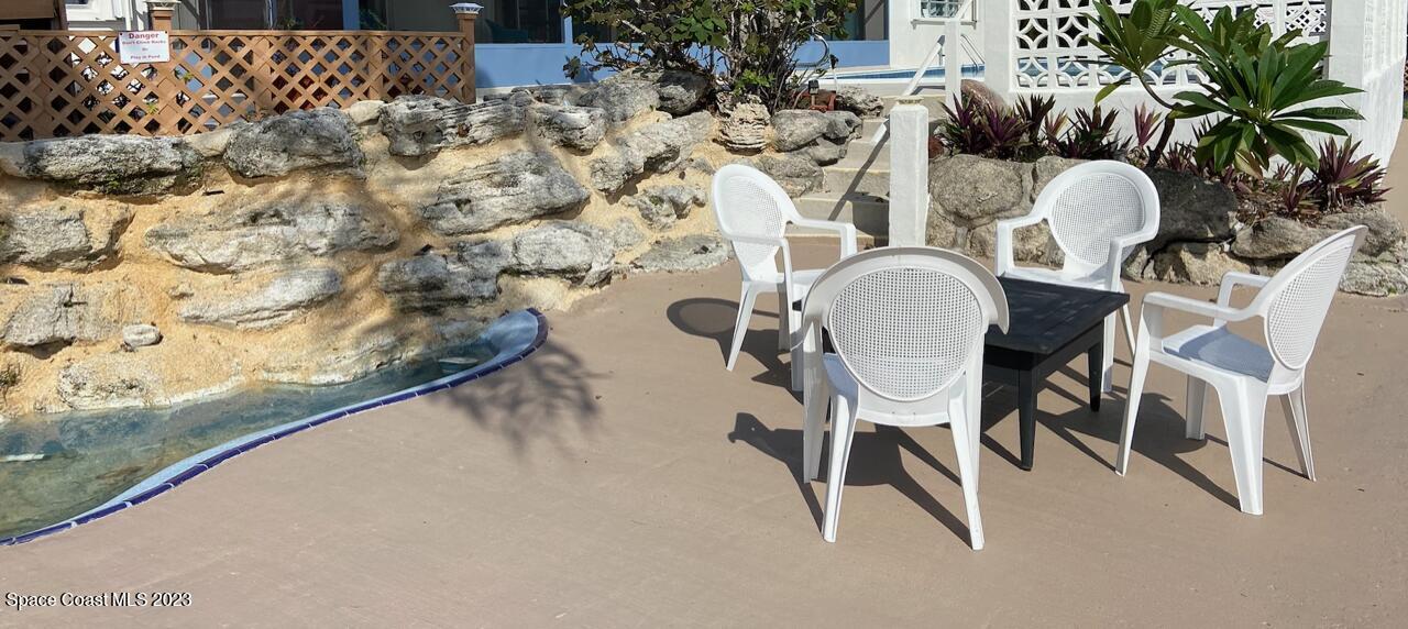 146 Bimini Road Cocoa Beach, FL 32931 - Photo 33 of 41 a balcony with table and chairs