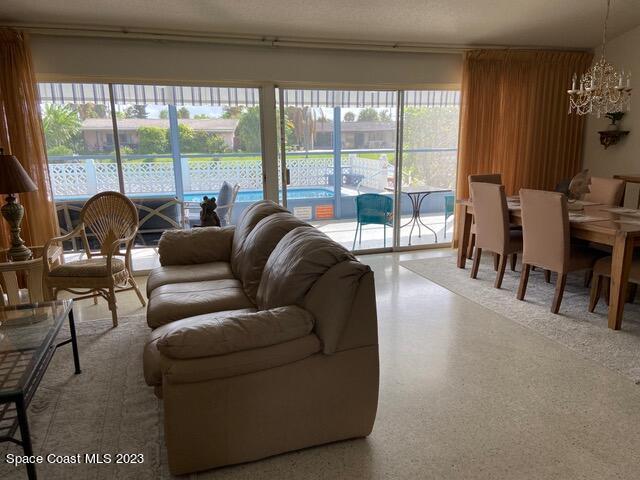 146 Bimini Road Cocoa Beach, FL 32931 - Photo 4 of 41 a living room with furniture and a large window