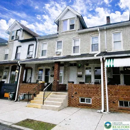 a front view of a residential apartment building with a yard