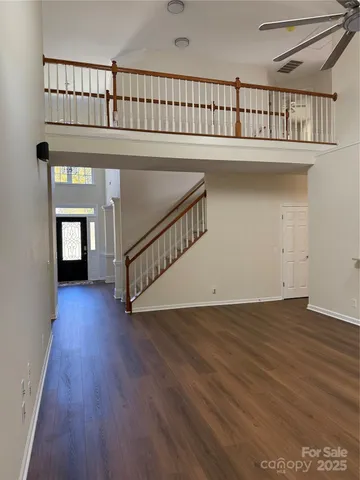 a view of staircase with white walls and a window
