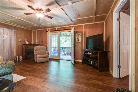 135 Shop Road Dunlap, TN 37327 - Photo 16 of 23 a living room with furniture a ceiling fan and a flat screen tv