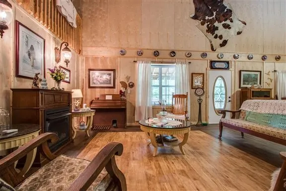 a living room with furniture a piano and a fireplace