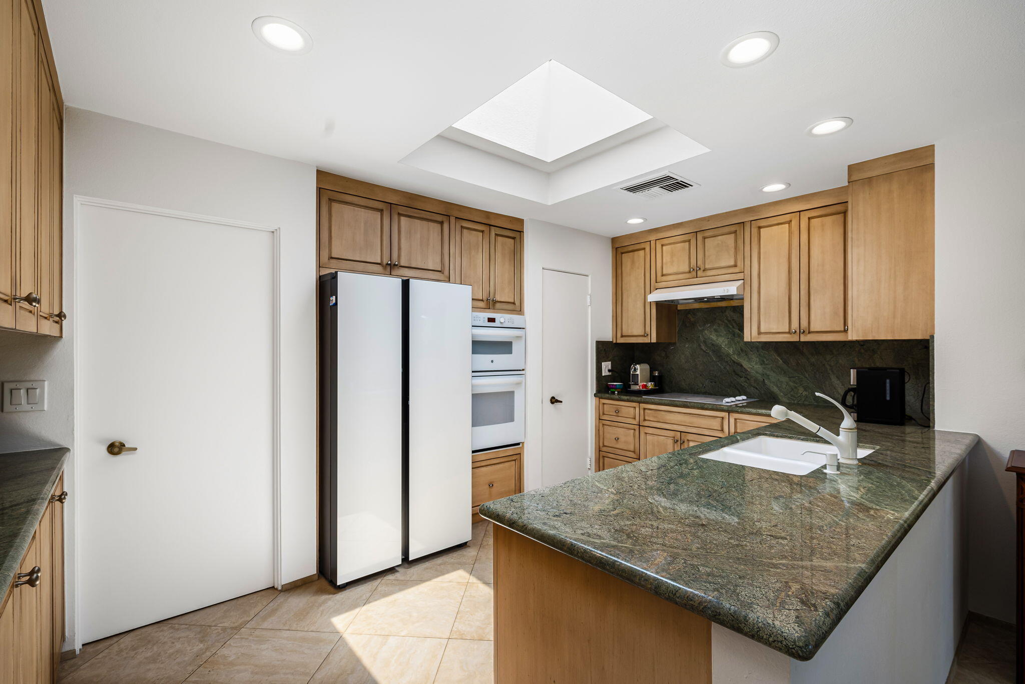 4 Reed Court Rancho Mirage, CA 92270 - Photo 11 of 42 a kitchen with a refrigerator a sink and a stove