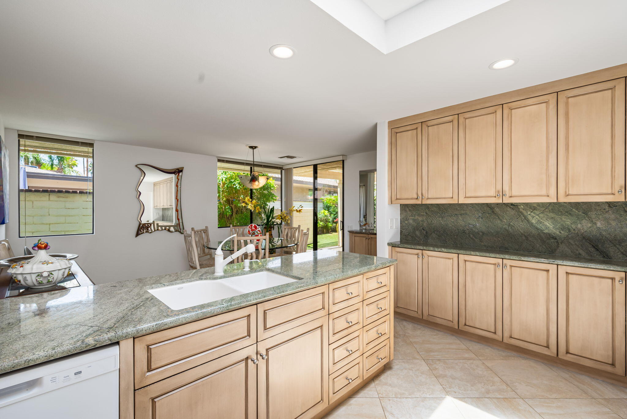4 Reed Court Rancho Mirage, CA 92270 - Photo 13 of 42 a kitchen with granite countertop white cabinets and white appliances