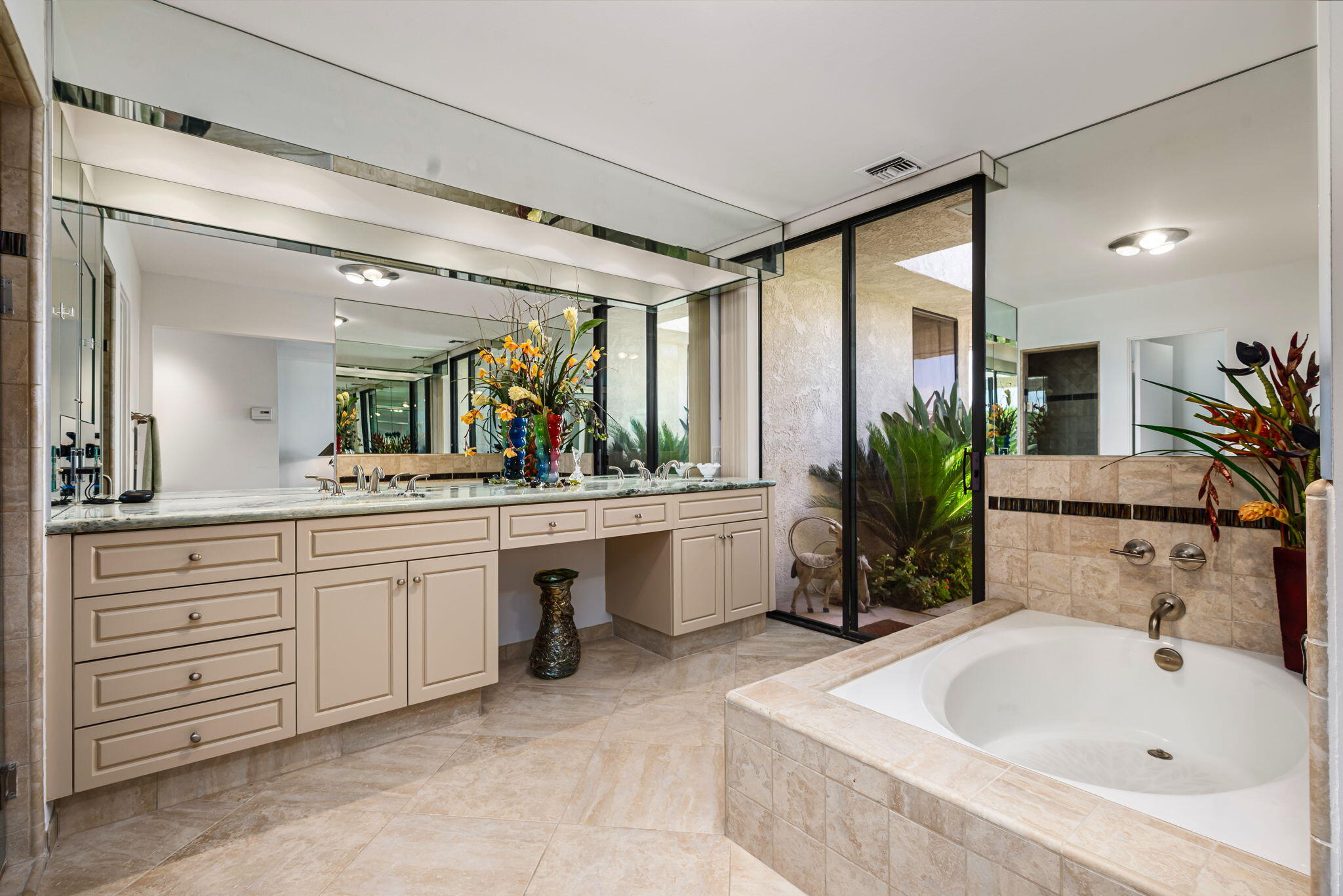 4 Reed Court Rancho Mirage, CA 92270 - Photo 17 of 42 a bathroom with a sink a large mirror and a bathtub