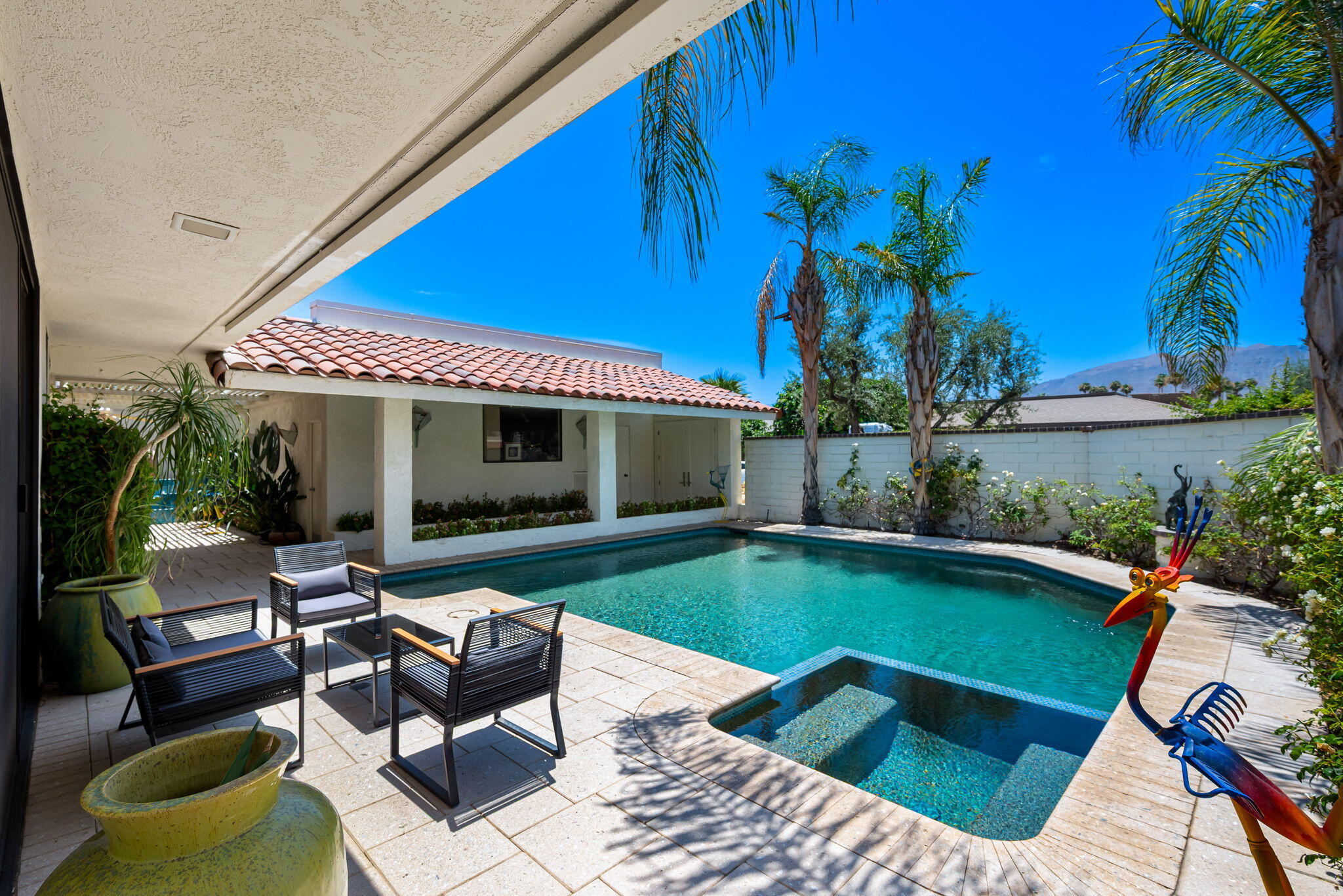 4 Reed Court Rancho Mirage, CA 92270 - Photo 31 of 42 a view of a house with swimming pool and sitting area