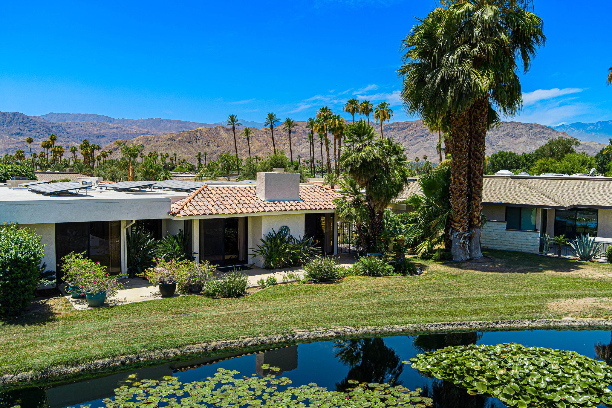 4 Reed Court Rancho Mirage, CA 92270 - Photo 32 of 42 a front view of a house with a yard