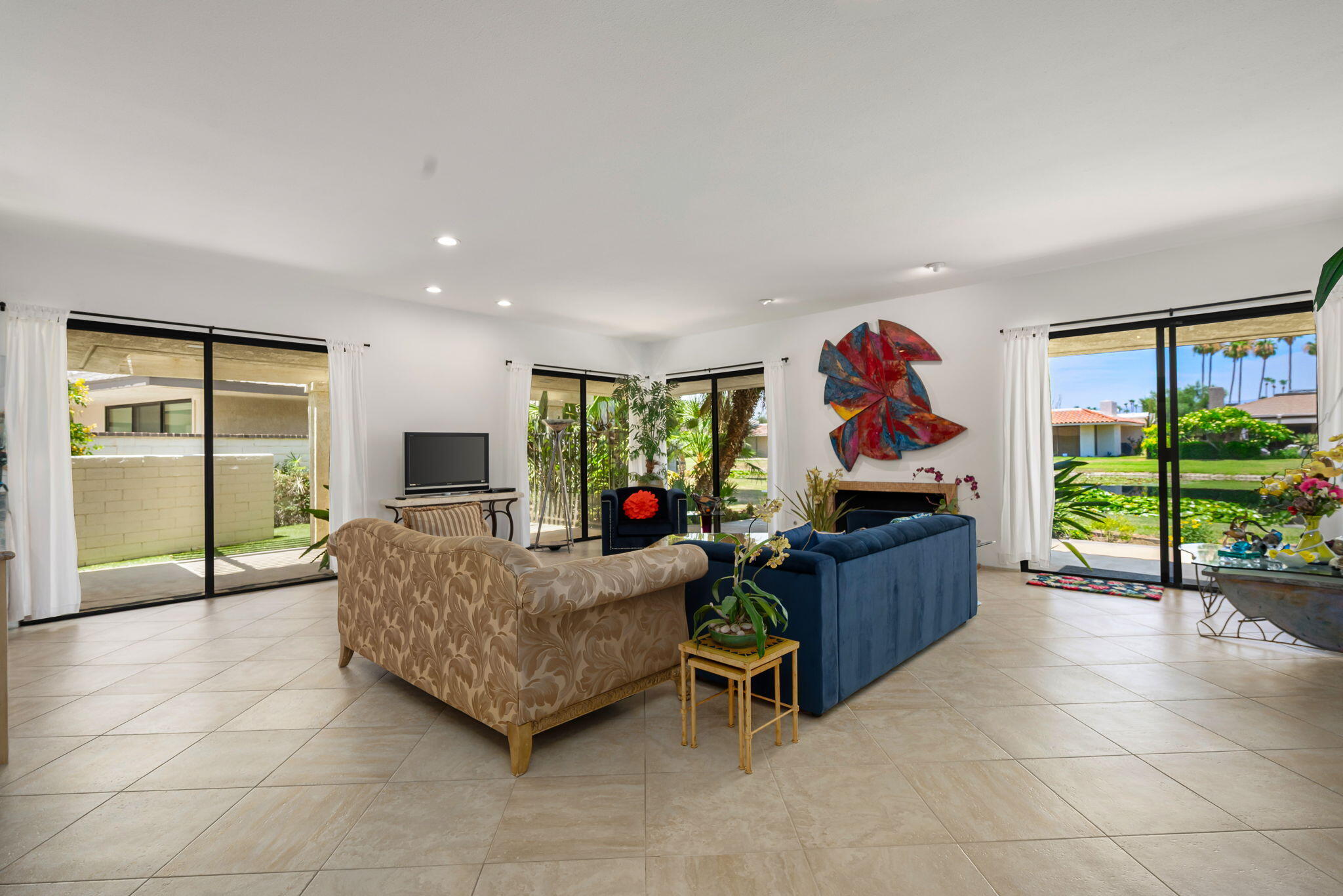 4 Reed Court Rancho Mirage, CA 92270 - Photo 5 of 42 a living room with furniture gym equipment and a large window