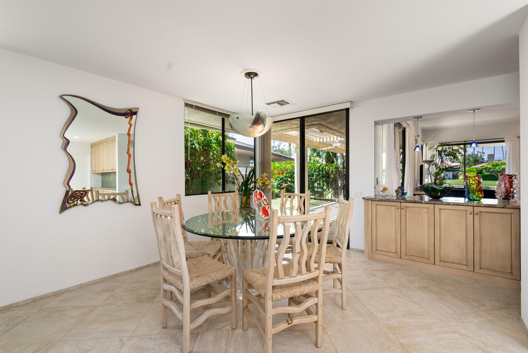 4 Reed Court Rancho Mirage, CA 92270 - Photo 9 of 42 a dining room with furniture a chandelier and wooden floor