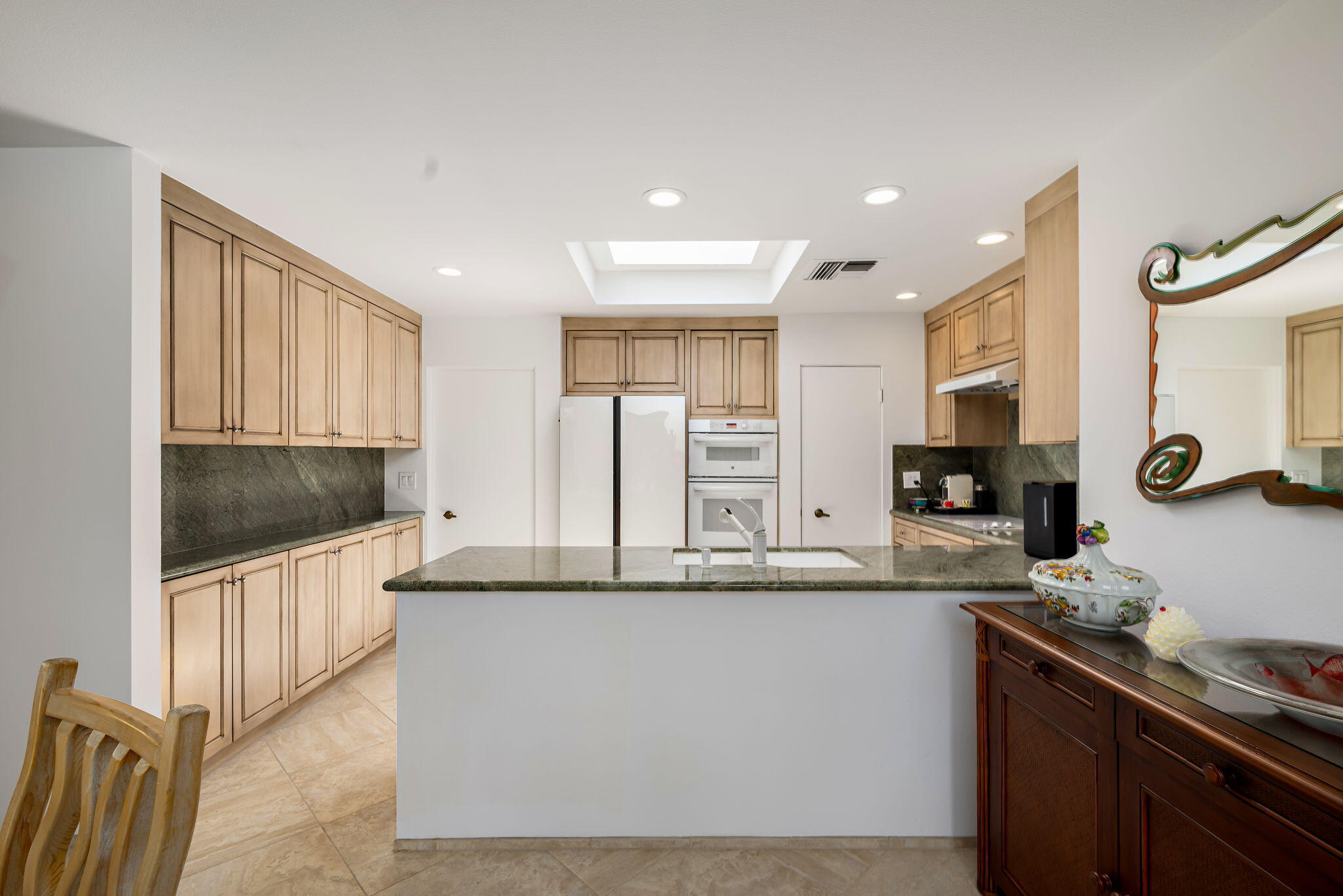 4 Reed Court Rancho Mirage, CA 92270 - Photo 10 of 42 a kitchen with stainless steel appliances granite countertop a sink and a stove top oven with wooden floor