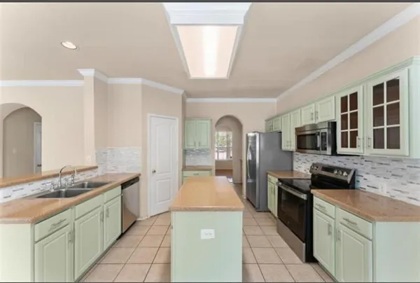 a large kitchen with stainless steel appliances granite countertop a stove and a sink