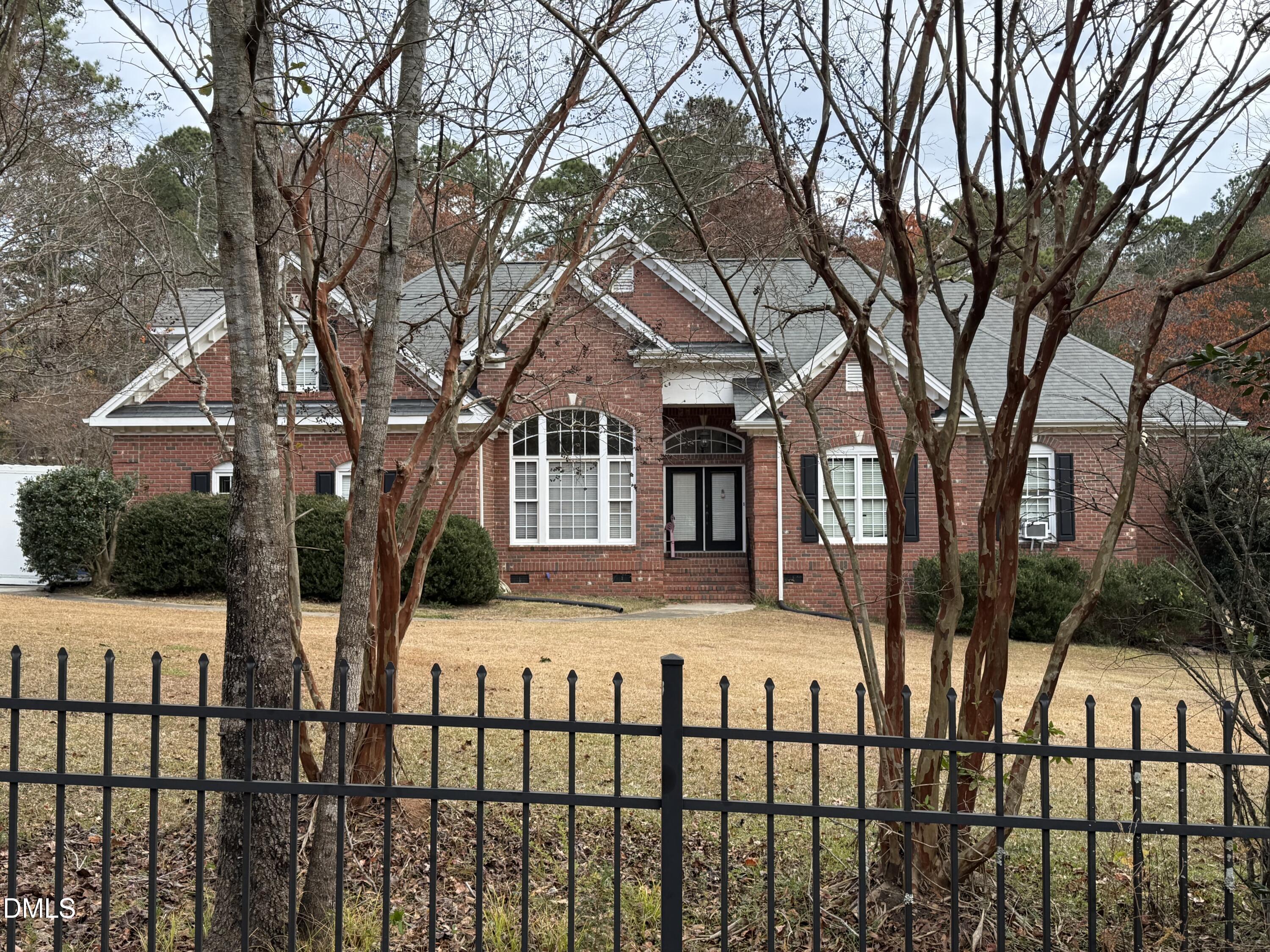 714 Moncure School Road Moncure, NC 27559 - Photo 1 of 7 a view of a white house with a large tree and a yard