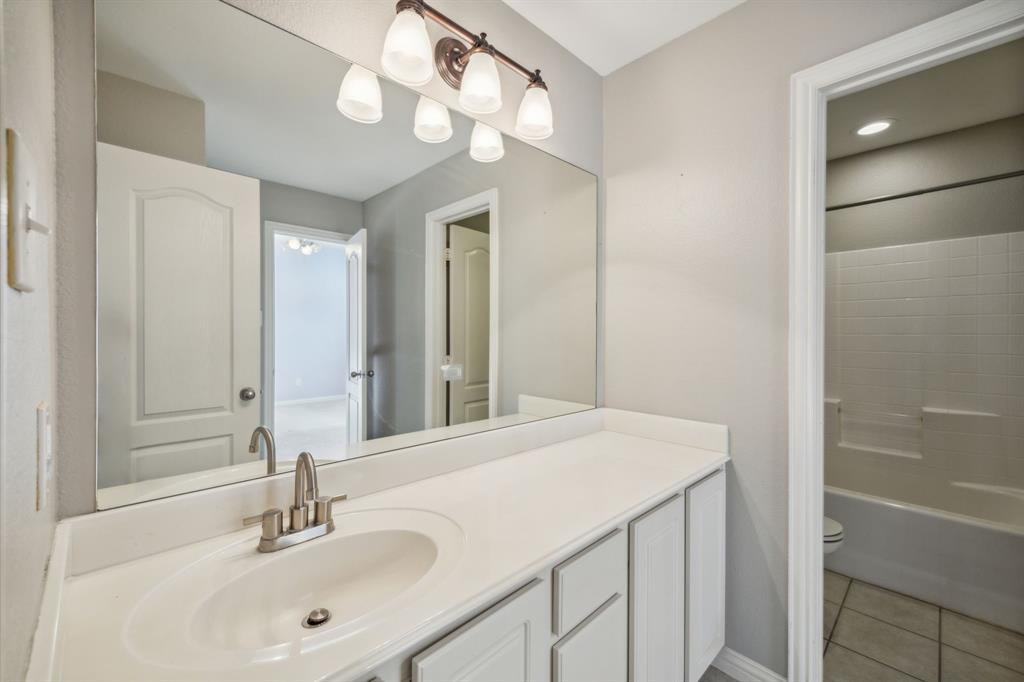 1302 Briar Ridge Drive Keller, TX 76248 - Photo 28 of 39 a bathroom with a sink a light fixture and a mirror