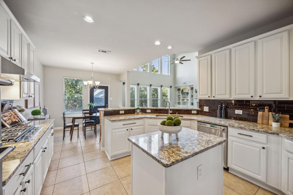 1302 Briar Ridge Drive Keller, TX 76248 - Photo 6 of 39 a kitchen with stainless steel appliances granite countertop dining table chairs and white cabinets