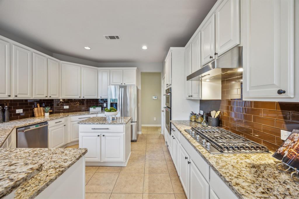 1302 Briar Ridge Drive Keller, TX 76248 - Photo 7 of 39 a kitchen with a stove top oven sink and cabinets