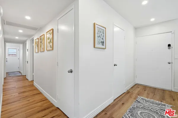 a view of hallway with wooden floor
