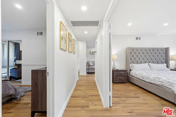 a view of a bedroom with wooden floor and bedroom